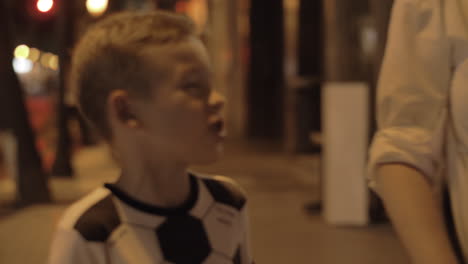 mum and children having evening walk in the city