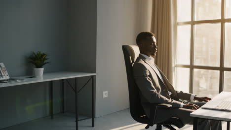 a professional man relaxing in a sunlit office