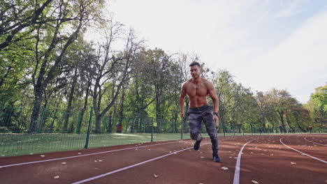 man running on a track in a park