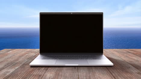 laptop on a wooden table with ocean background