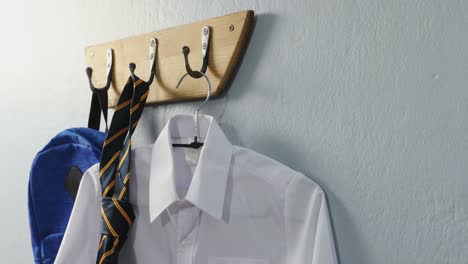 School-uniform-and-school-bag-hanging-on-hook-4k