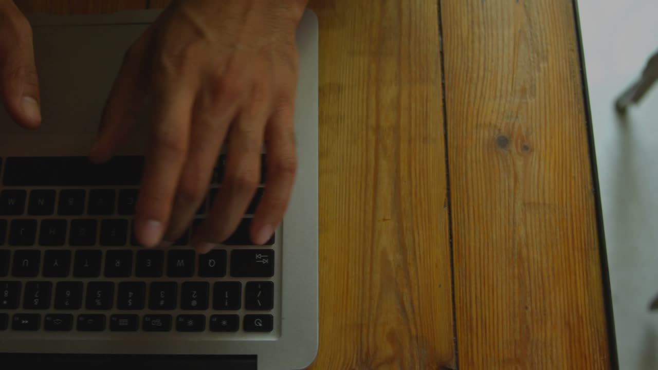 Hands starting typing, HUD overlays appearing and growing over laptop keyboard to visualize data