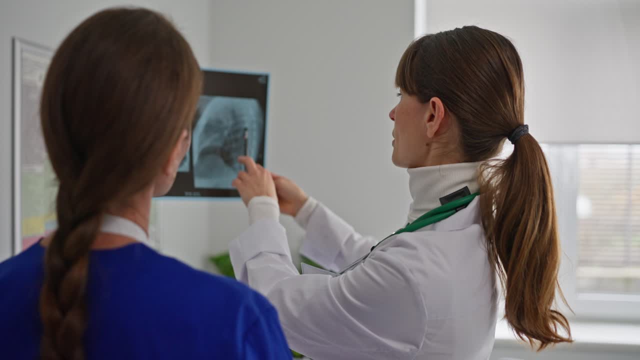 Doctor and Nurse Reviewing X-Ray Images