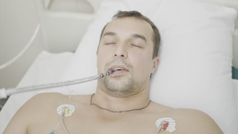 patient in hospital bed with medical equipment