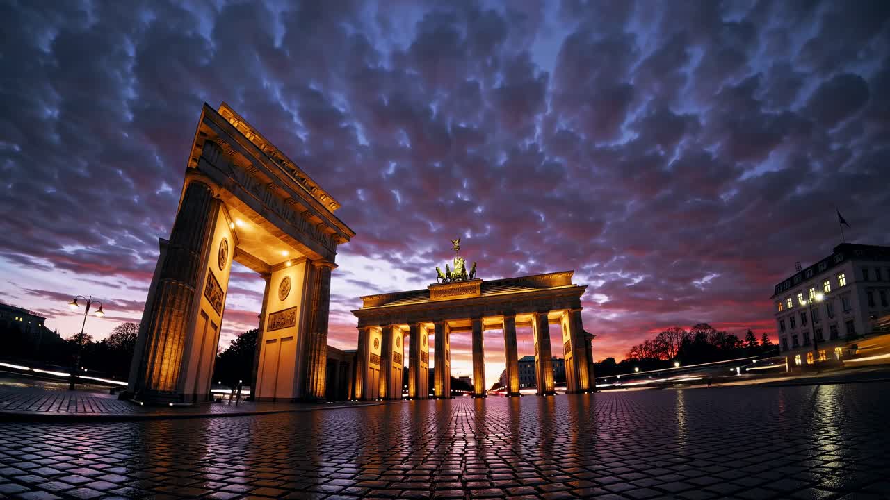 Dramatic low-angle video shot of the Brandenburg Gate at dusk, capturing the illuminated structure