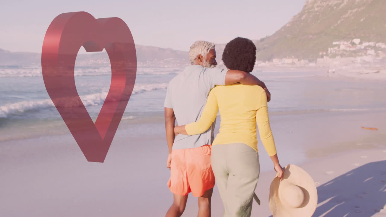 Couple walking on beach with heart-shaped animation over ocean background