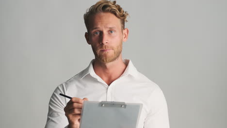 bored businessman writing paper on clipboard