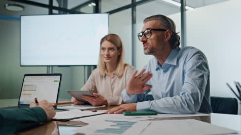 business group brainstorming ideas meeting closeup. inspired businessman talking