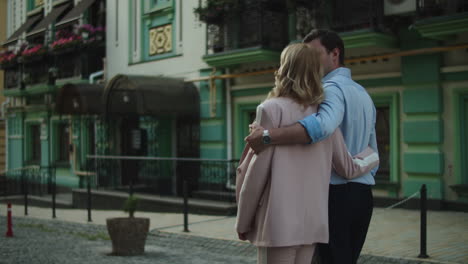 back view business couple walking at street. couple talking with each other