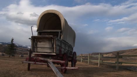 Only-A-Splitrail-Fence-Separates-A-Historic-Coveredwagon-From-A-Modernday-Day-Road-Traveled-By-Cars