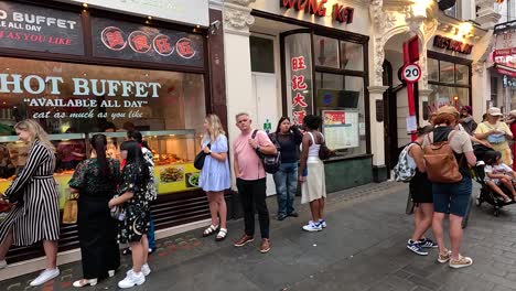 people walking and interacting in chinatown, london