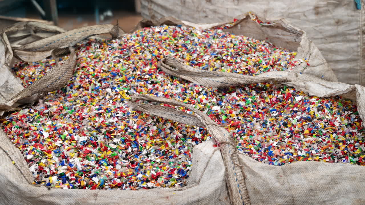 Sack of sorted multicoloured plastic garbage at waste recycling factory