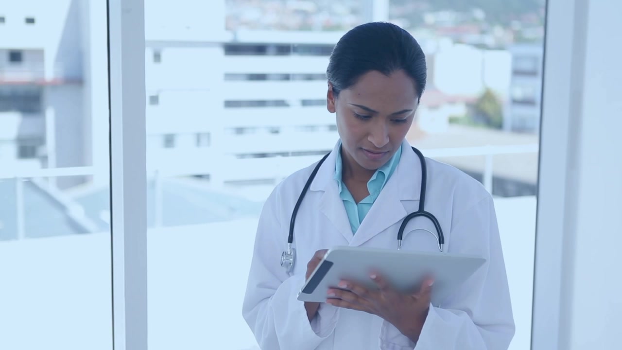 Animation of patterns over female doctor using tablet
