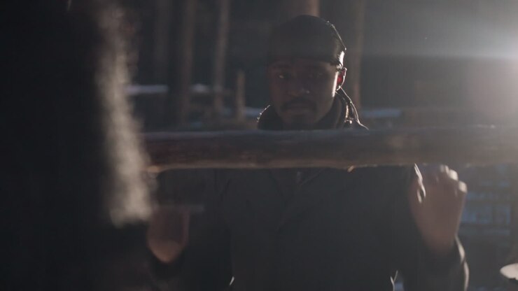 black man lifting log in forest at sunrise, rugged lumberyard backdrop, strong silhouette and backlight sunflare, cold air visible, focused expression and manual labor conveying determination