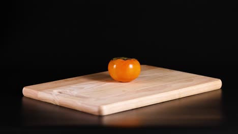 persimmon rotates on a wooden cutting board