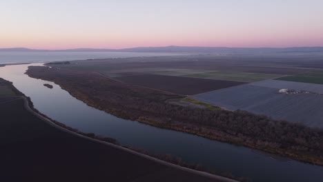 Salinas-river-flowing-into-Monterey-bay-with-flat-farm-fields-landscape-around