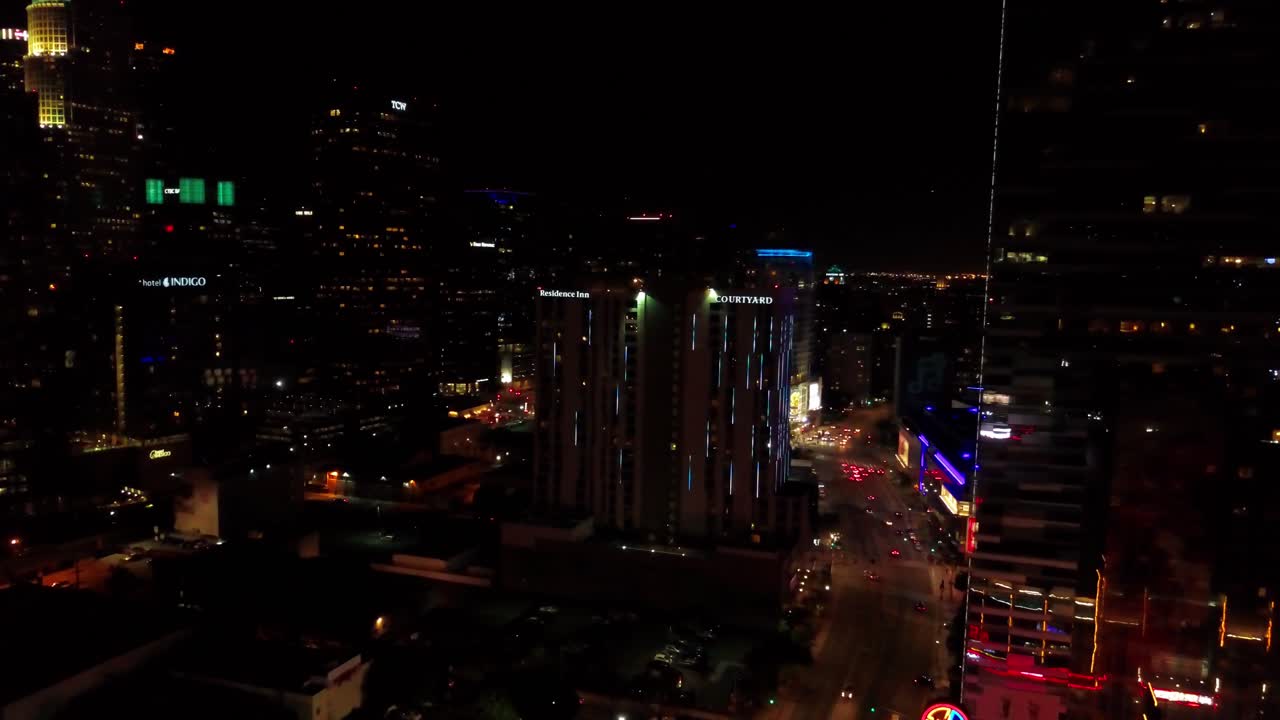 Aerial reverse pull back shot of LA Live in Downtown Los Angeles at night. 4K
