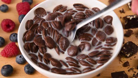 stirring a bowl of freshly made chocolate cereal