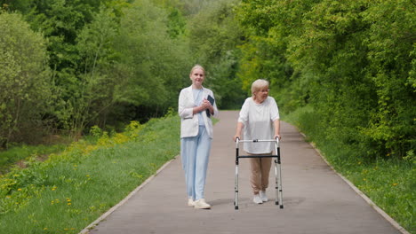 nurse assisting elderly woman in park