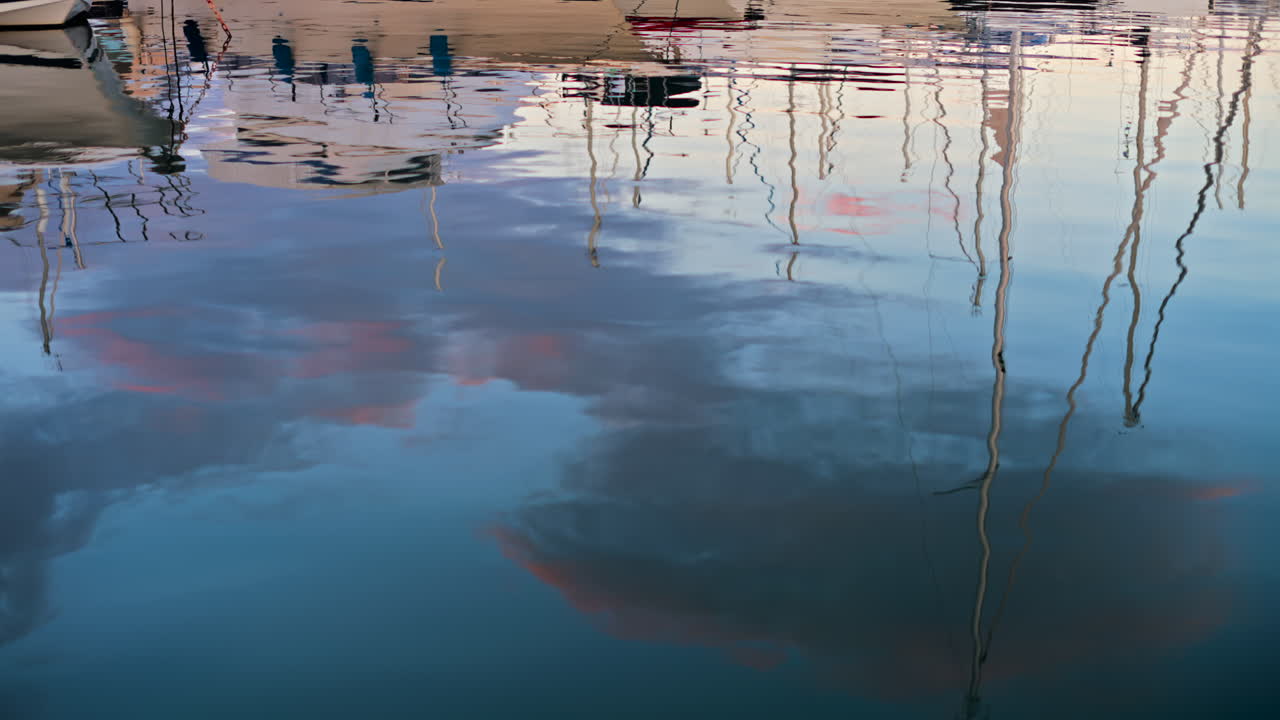 Reflection on the sea of white boats docked in the Port Vauban at sunset in Antibes, France
