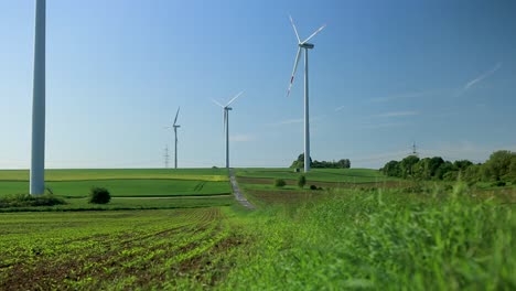 non-moving, still standing wind turbines, beautiful green field in rural germany