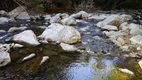 Still-footage-of-water-flowing-through-rocks-in-Freshwater-Creek,-near-Cairns,-Queensland,-Australia