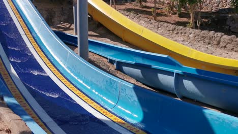 child on water slide at aquapark. summer holiday.