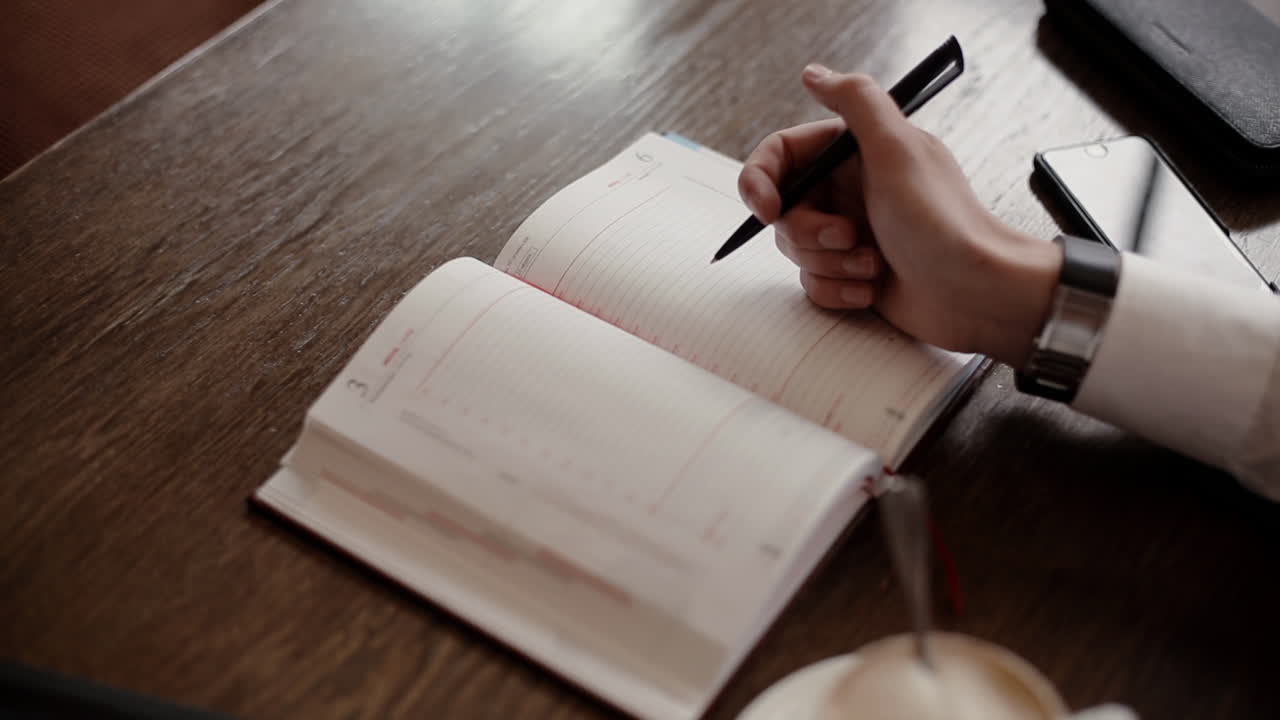 Person taking notes at a cafe