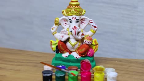 hindu holy god ganpati colorful idol with colors on the occasion of ganesh chaturthi