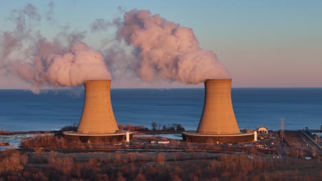 steam from enrico fermi ii nuclear power plant cooling towers at sunset, berlin township, michigan, usa