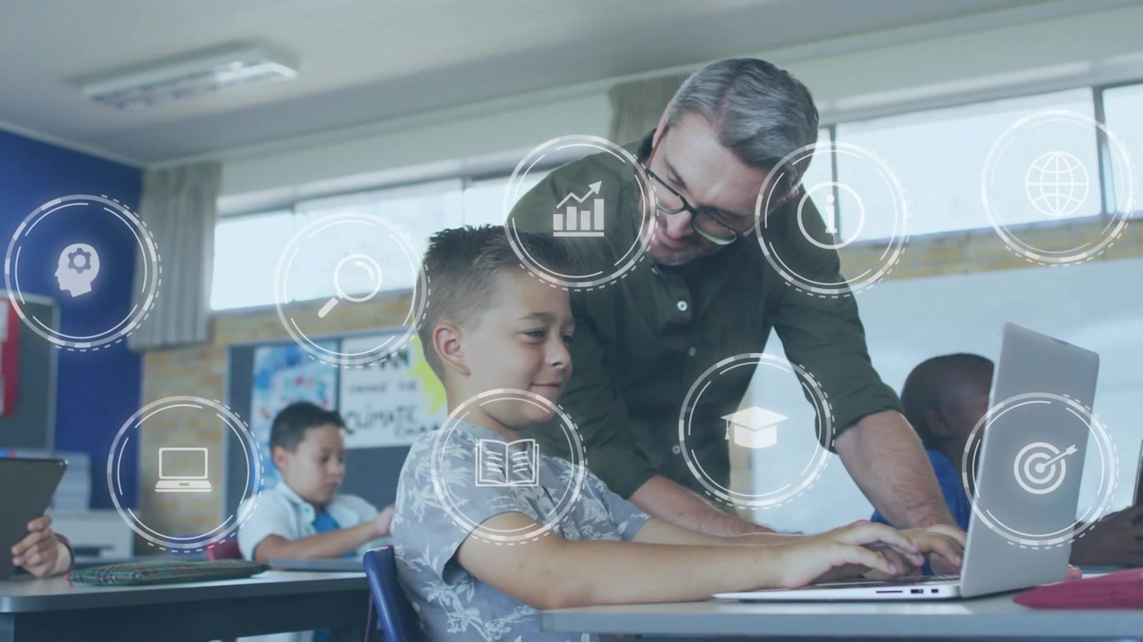 Teacher leaning over student and guiding typing, book and globe icons overlaying scene for lesson
