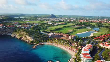 Dolly-in-aerial-view-of-Blue-Bay-beach-in-Curacao,-Dutch-Caribbean-island