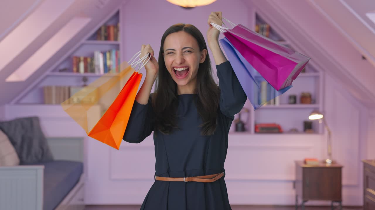 chica india feliz sosteniendo bolsas de compras