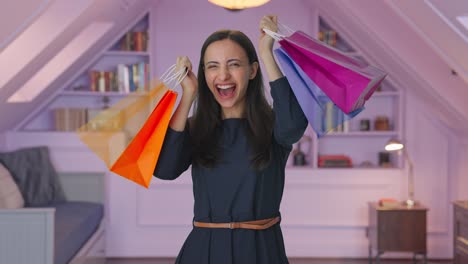 Happy-Indian-girl-holding-shopping-bags