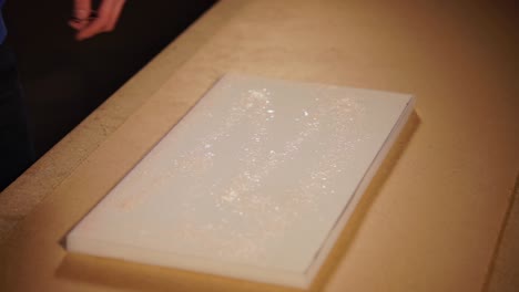 spray painting glitter onto a surface