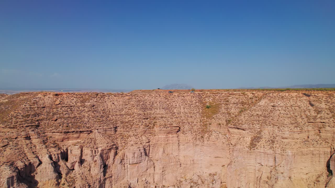 Cars on top of a ridge in the Gorafe desert, Granada, Andalusia, Spain