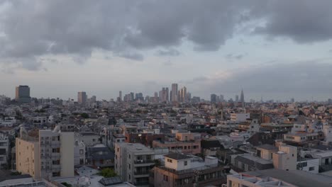 Aerial-shot-of-Tokyo-city-during-sunset,-concrete-jungle-all-over-the-horizon