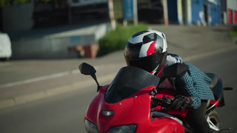 a lady rides a power bike, resting her body forward on the bike while wearing a helmet, her shirt flutters in the wind, partially revealing her bod