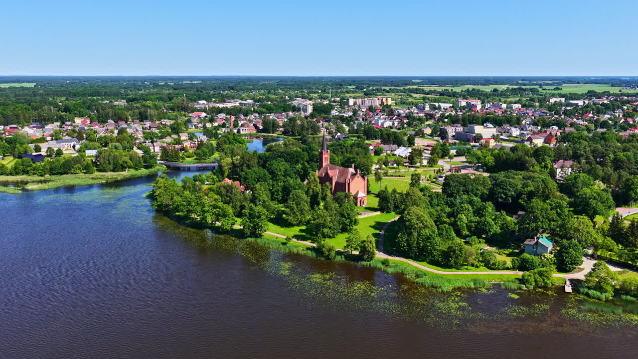 Biržai township and beautiful red brick church with tower, aerial view