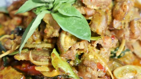 Close-Up-Footage-of-Thai-Exotic-Food,-Hot-and-Spicy-Stir-Fried-Wild-Boar-With-Kaffir-Lime-Leaves-and-Herbs