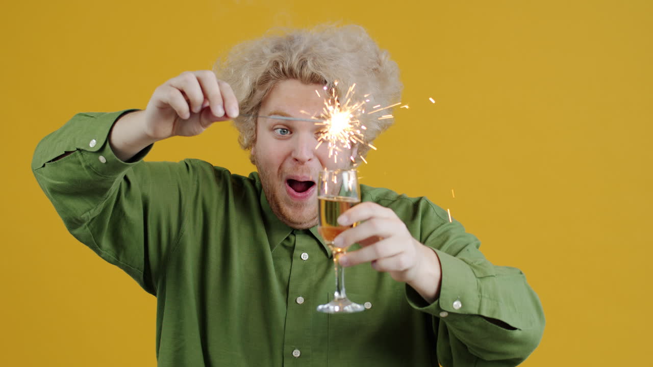 Man celebrating with sparkler and champagne