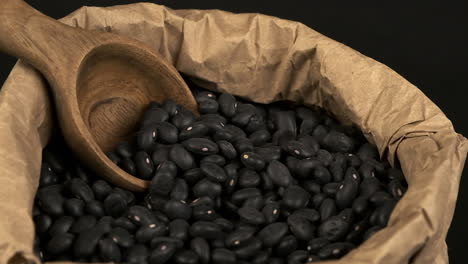 Macro-close-up-view:-Dried-Black-Turtle-Beans-rotate-in-paper-bag