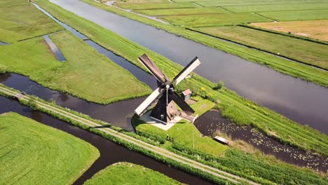 traditional windmill in dutch landscape aerial shot top down birds eye view