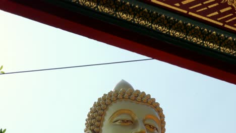 giant buddha reveal shot at wat paknam bhasicharoen bangkok thailand golden