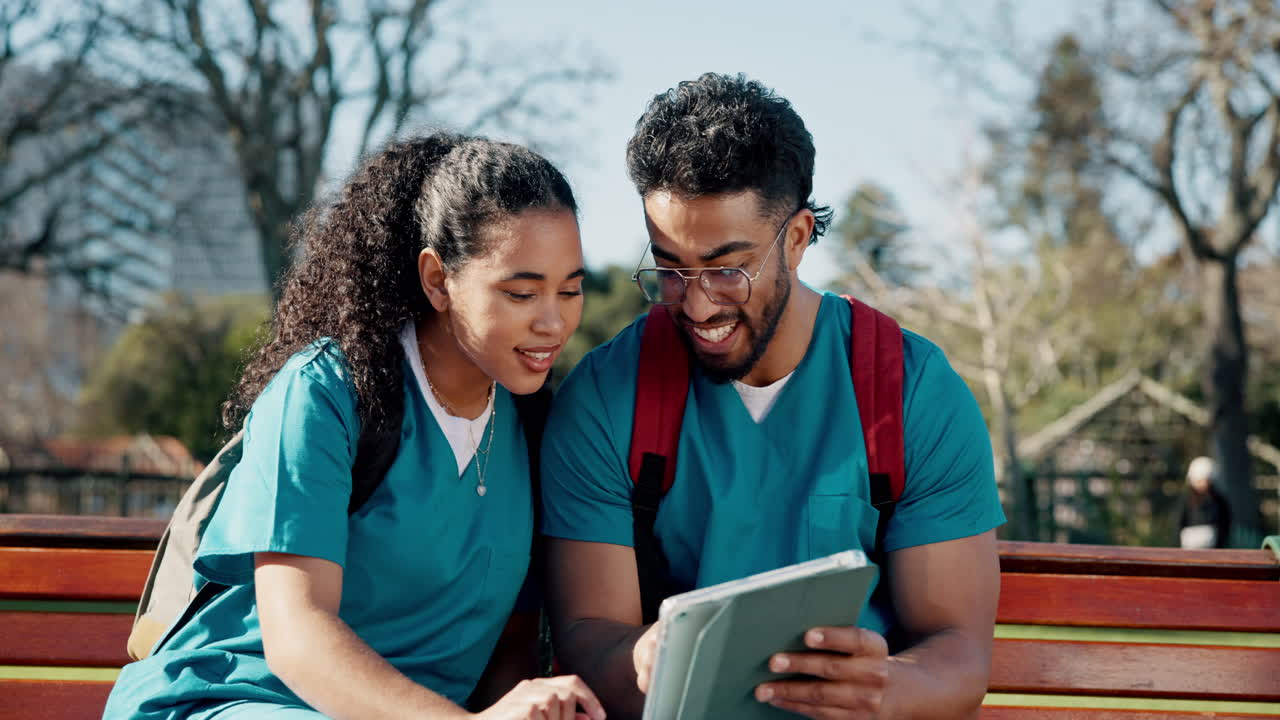Nursing students studying together in a park