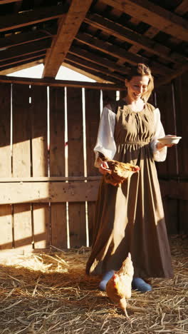 woman smiling while caring for chickens in a rustic coop