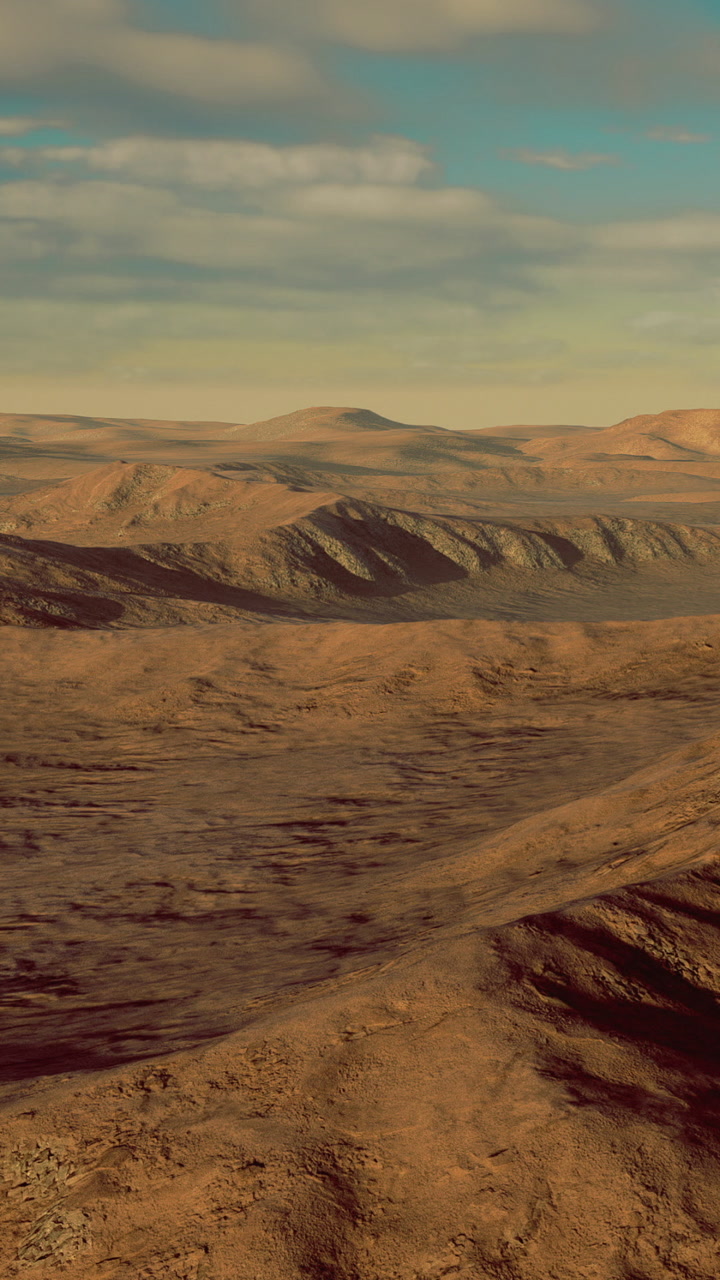 Mountainous landscape with rolling hills under a clear sky during daylight