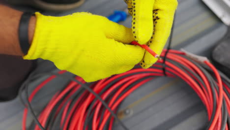 electrician working on wires on a rooftop