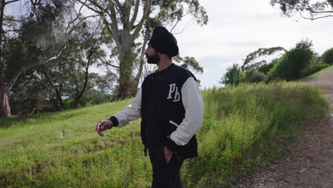 Indian-Sikh-Man-Walking-Downhill-In-Summer-Nature---medium-shot