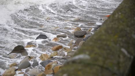 waves relentlessly breaking over rocks on the irish coastline